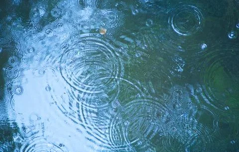 Rain drops falling in pool Stock Photos