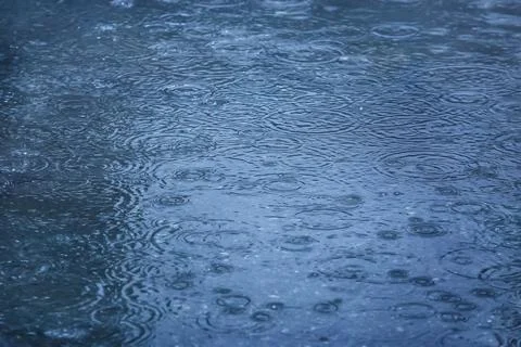 Rain drops falling in pool Stock Photos