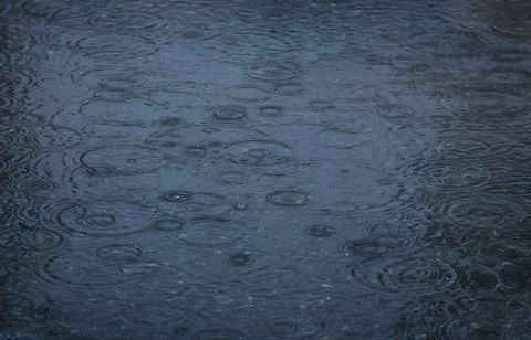 Rain drops falling in pool Stock Photos