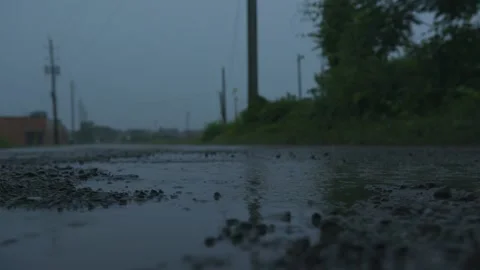 Rain drops falling on a puddle. Stock Footage 157947668