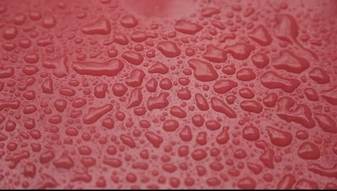 Rain drops falling on red surface  sideview Stock Footage 2269412