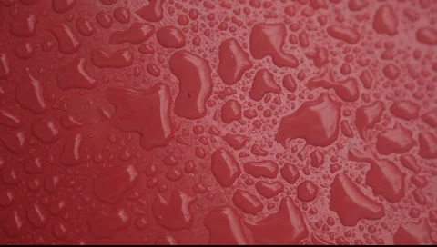 Rain drops falling on red surface closeup Stock-Footage 2270137