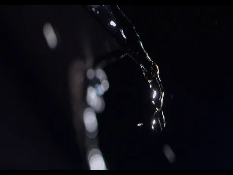 Rain drops falling from the rib of black umbrella, black background, slow motion Stock Footage 74214550