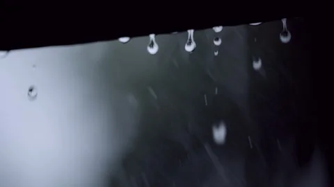 Rain Drops Falling From Roof Edge During Thunderstorm With Lightning Flash Stock Footage 336929295