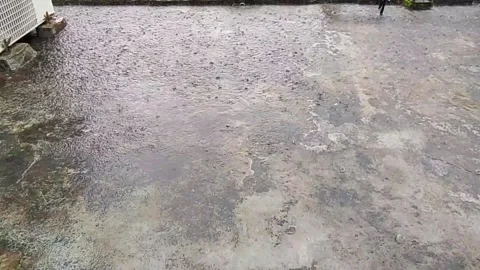 Rain drops falling on a rooftop surface during a heavy downpour storm raindrops Vídeos de archivo 342428578