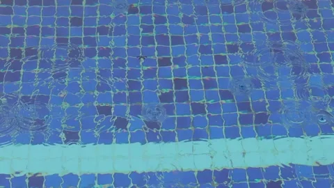 Rain drops falling in a swimming pool Stock Footage 292283620