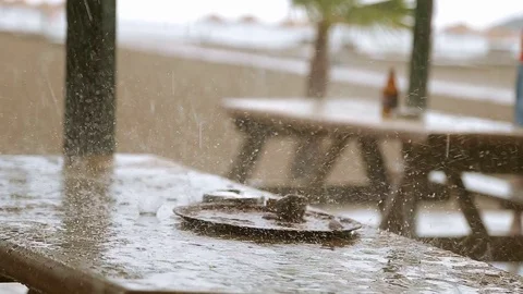 Rain drops is falling on the table Stock Footage 76984302