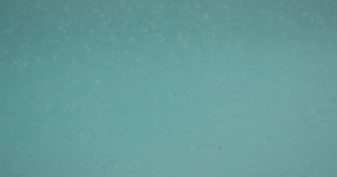 Rain drops falling into torquoise water in slow motion Stock Footage 150643523