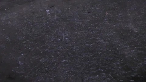 Rain drops falling in the water in dark place Stock Footage 114386187