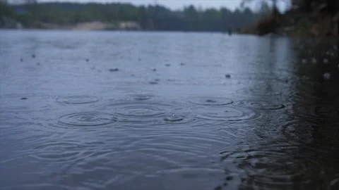 Rain drops falling water evennig Stock Footage 130654589