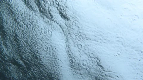 Rain drops falling on the water surface. Underwater view Stock Footage 232243808