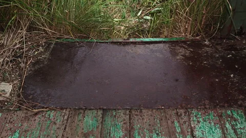 Rain Drops Falling on Wet Metal Threshold of Abandoned Trailer Stock Footage 339589980