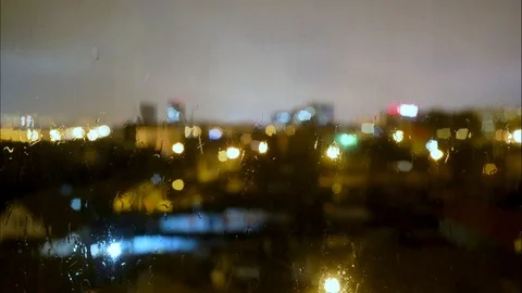 Rain Drops Falling on window with bokeh light effects in the background. Video stock 126825494