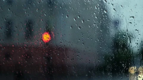 Rain Drops Falling on window with bokeh light effects. Heavy rain inside a car Stock Footage 161780211