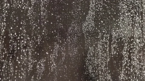 Rain drops falling on the window glass, selective focus, autumn colors. 動画素材 86546873