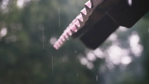Rain Drops flow down from the roof Slow motion Rain hitting haus rooftop Strong Stock Footage 172412527