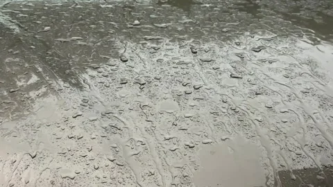 Rain drops flowing on wet surface during storm Video stock 320949466