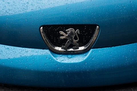 Rain drops on front car of blue Peugeot 108 parked in the street Stock Photos