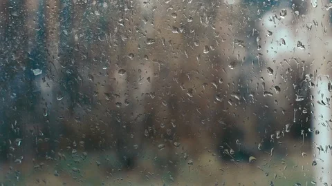Rain drops on glass against background of cars passing by Stock Footage 89403254