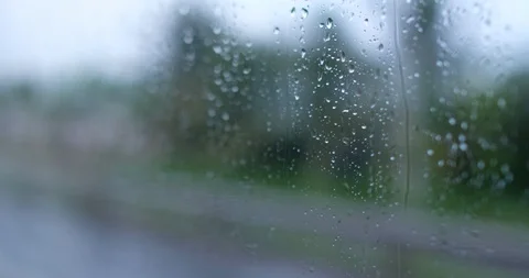Rain drops on glass car window moving on... | Stock Video | Pond5
