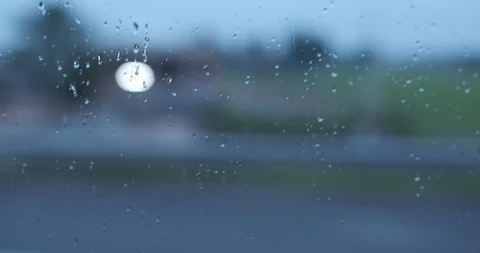Rain drops on glass car window moving on the road Stock Footage 102992613