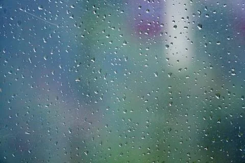 Rain drops on the glass. Drops of water on an autumn day on a glass. Abstra.. Stock Photos