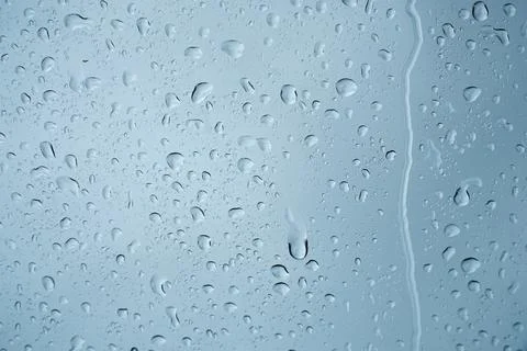 Rain drops on the glass surface. Stock Photos