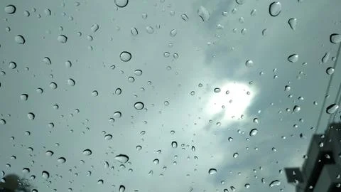 Rain drops on glass window background Stock Photos