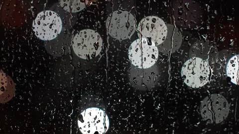 Rain drops on glass window with night city lights on background, close-up. .. Stock Footage 287296358