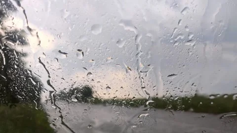 Rain drops on glass windscreen, moody close-up Stock Footage 252929406