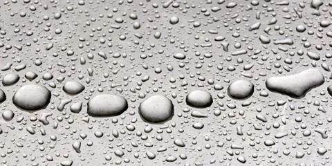 Rain drops on a gray metallic background Stock Photos
