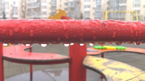 Rain Drops Hanging on the Carousel Bar in the Empty Playground Stock Footage 123724404