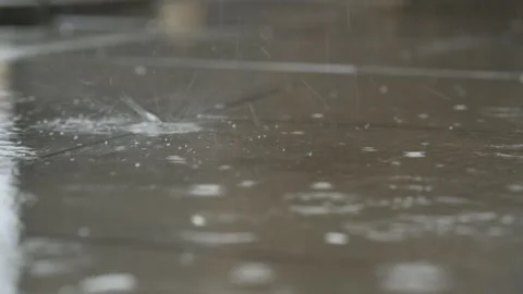 Rain drops hitting ground, splashes on wet surface Stock Footage 331036310