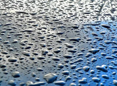 Rain drops on metallic surface Stock Photos