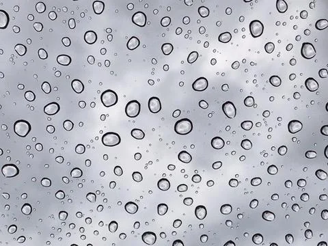 Rain drops at mirror with cloudy sky Stock Photos