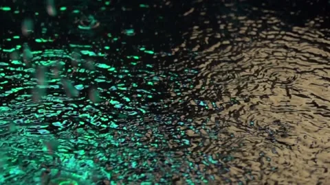 Rain drops in the night city. Multicolored lights. Slow motion. Stock Footage 90950965