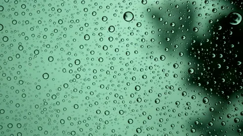 Rain drops or water droplets on clear glass on a blurred nature background. Stock Footage 139744284