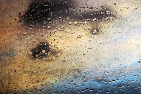 Rain drops over the window at sunset Stock Photos