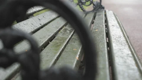 Rain drops on a park bench in close up view. Stock Footage 155450321
