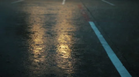 Rain drops on pavement with light reflections Stock Footage 49494082