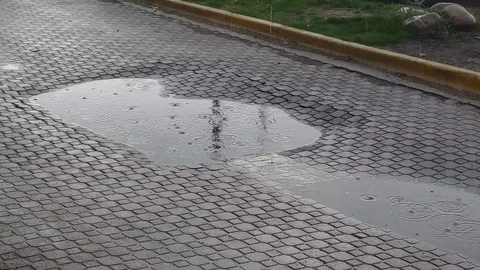 Rain drops in Puddle on Brick Street Stock Footage 107064772