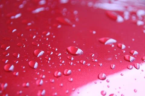 Rain Drops On Red Car Surface Stock Photos