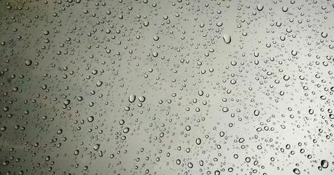 Rain drops on red glass window background Stock Photos
