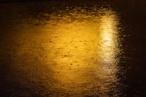 Rain drops on a river at night texture Stock Photos