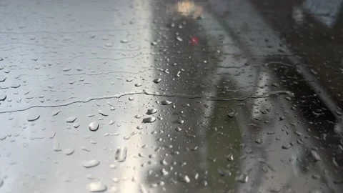 Rain drops rolling down on the window with traffic at the background. Vertical Stock Footage 211714439