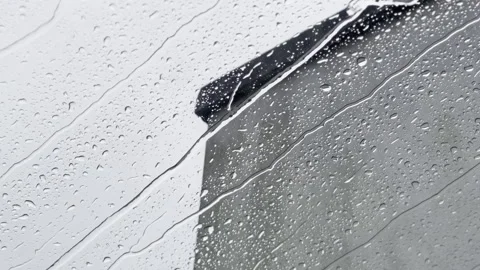 Rain drops run down glass window skylight on a moody overcast day bad weather Stock Footage 297850561