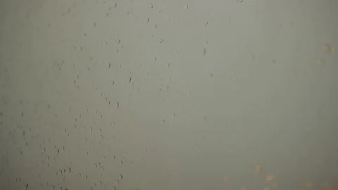 Rain drops run down window pane, lightning sparkles on blurred background Stock Footage 80433336