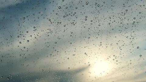 Rain drops runnin down the window glass at rainy day Stock Photos