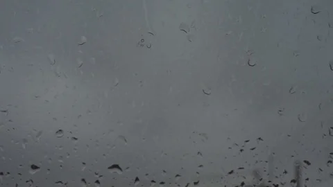Rain drops running down a window pane. Focus on drops. Stock Footage 87142787
