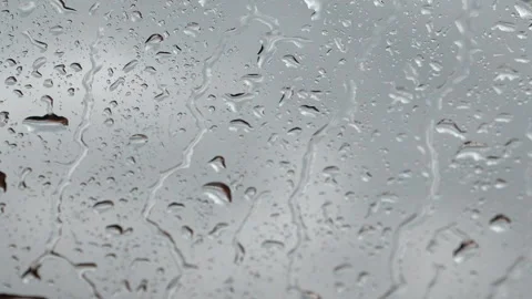 Rain drops running down a window glass pane Video stock 337800235